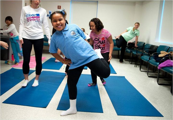 Girl stretches left leg during exercise session