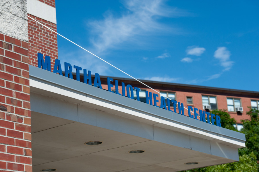 sign outside of brick building that says 'martha eliot health center'