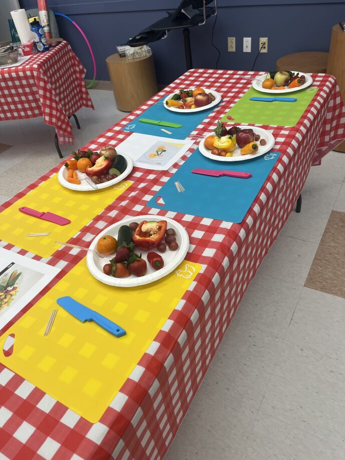 Paper plates with fruits, vegetables lay on table
