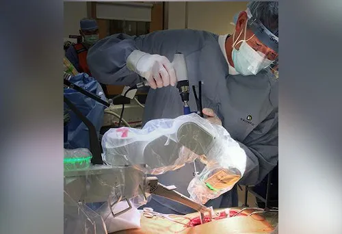 Clinician performs spinal surgery