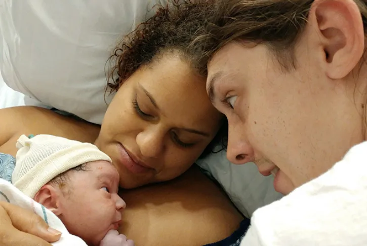 Parents hold young child