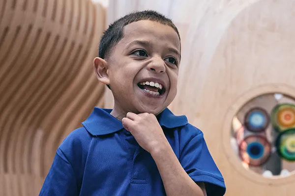 Boy with short haircut smiles