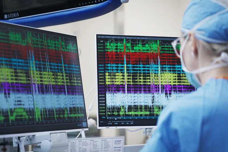 Surgeon looks at screen showing data