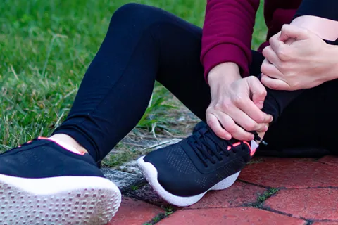 Runner grabs left ankle